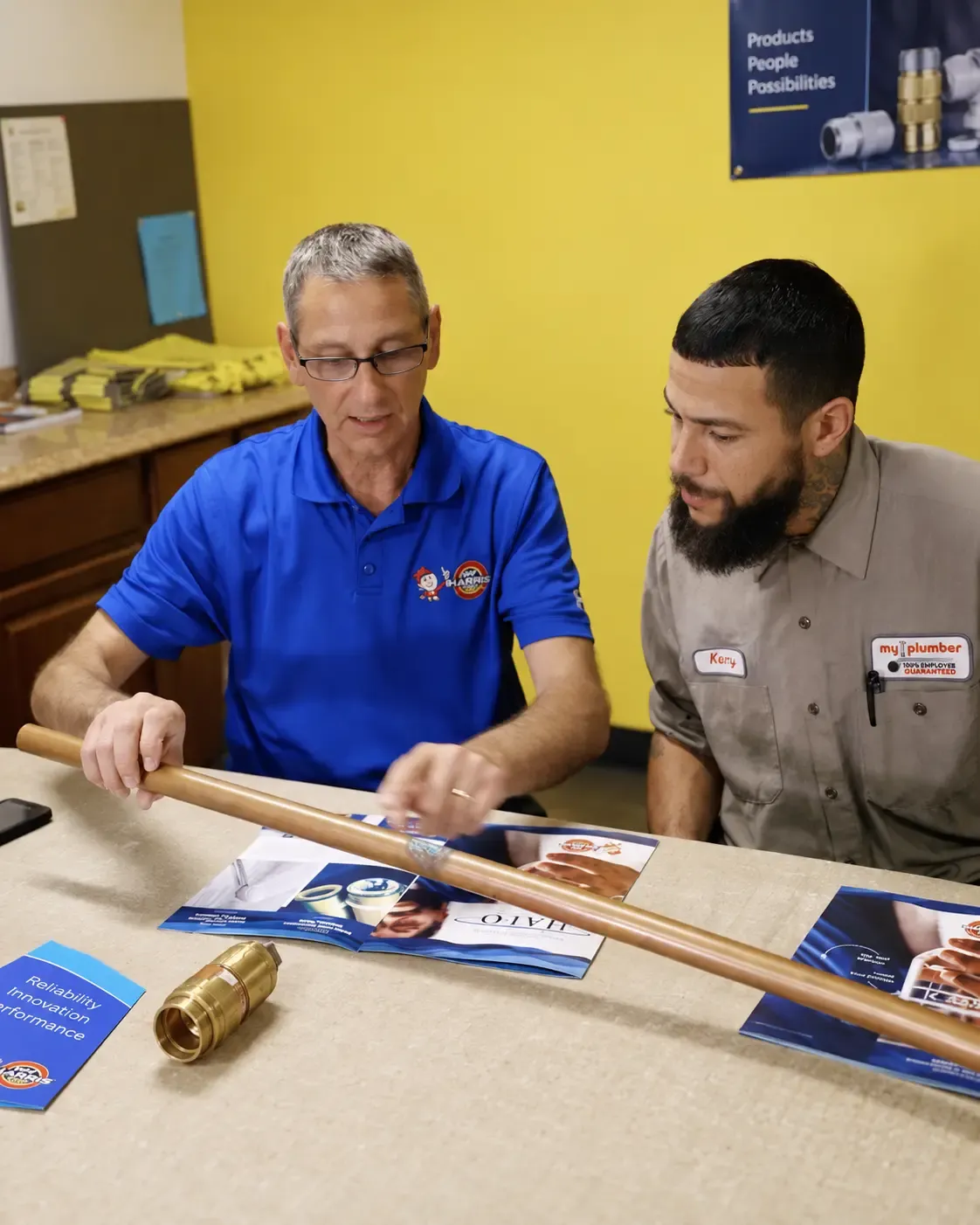 FlyPoint Productions filming a product installation training video with two technicians demonstrating copper pipe fitting.