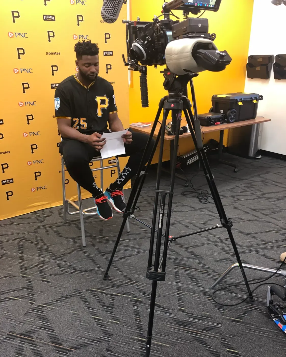 FlyPoint Productions filming a social media video with a seated presenter, cinema camera, and boom microphone.