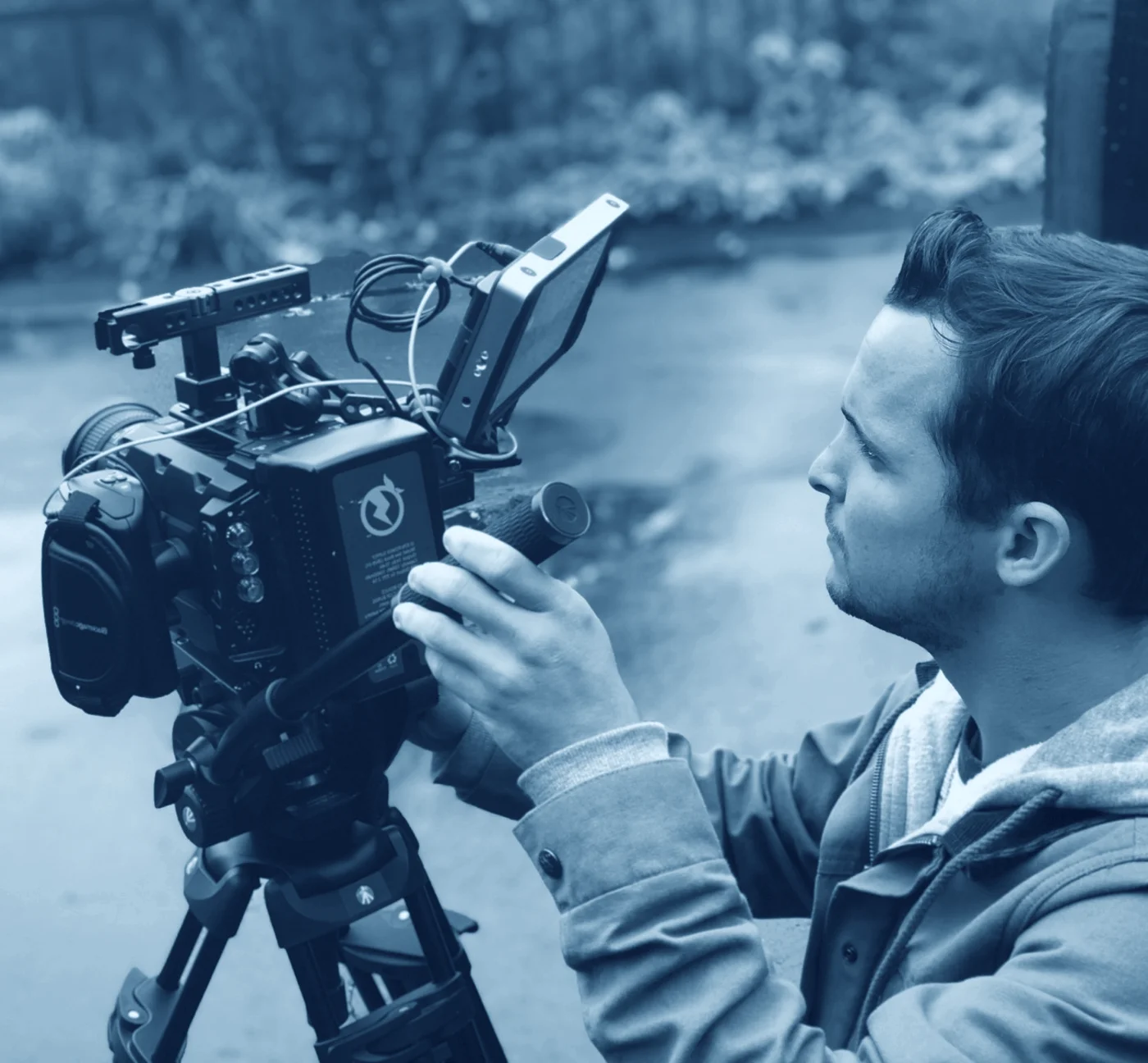 FlyPoint Productions camera operator filming with a professional cinema camera.